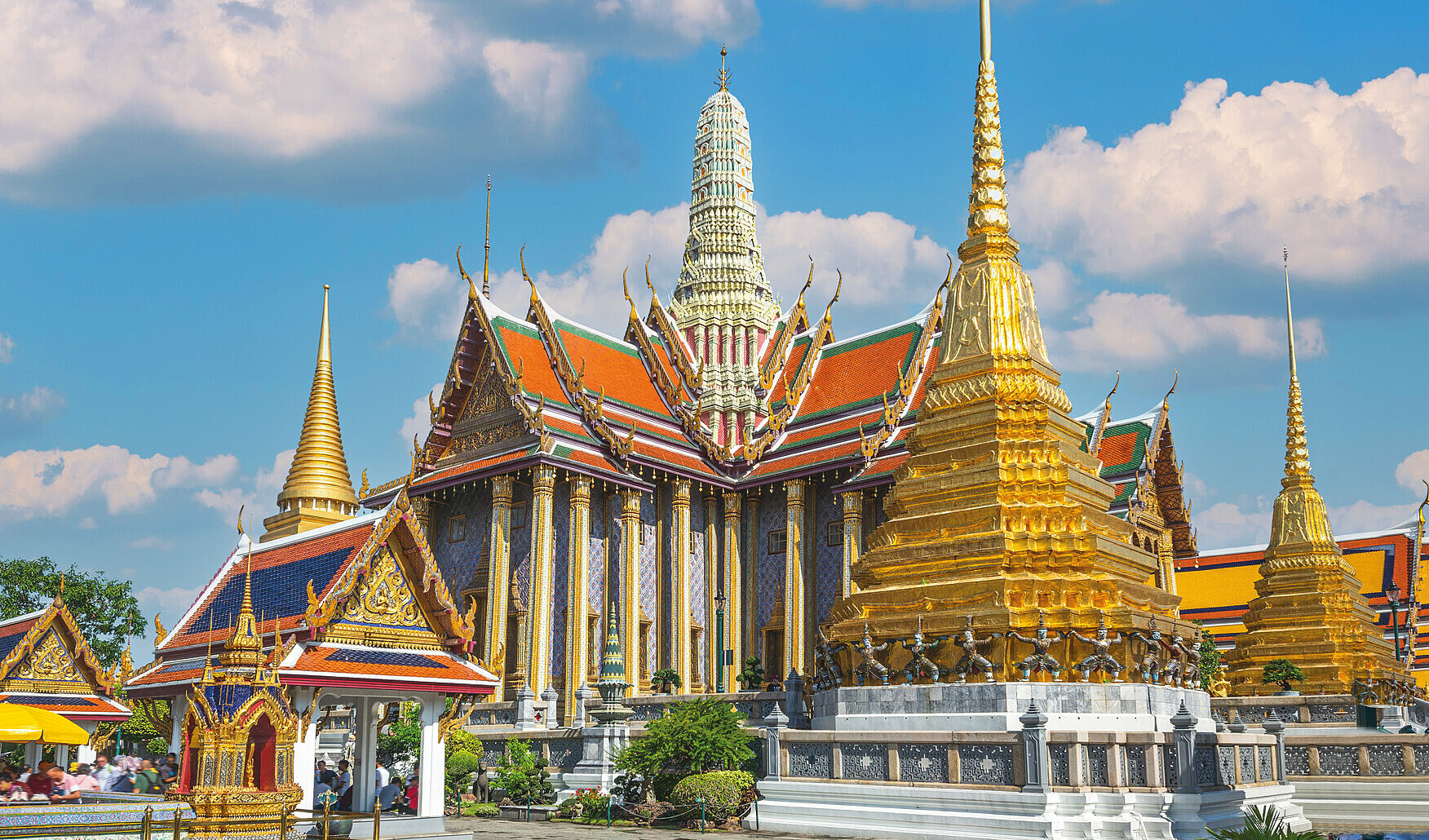 The Grand Palace, a landmark in Bangkok, with a blue sky in the background