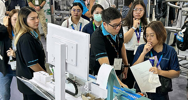 Advising Asian prospects at a trade Show